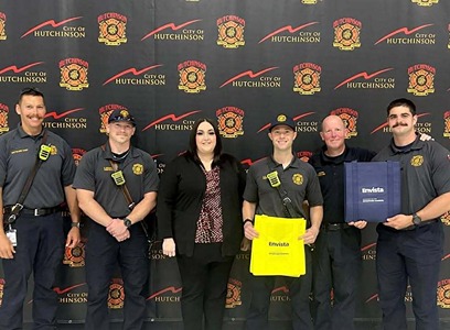 An Envista Employee presents gifts to five members of the Hutchinson Fire Department