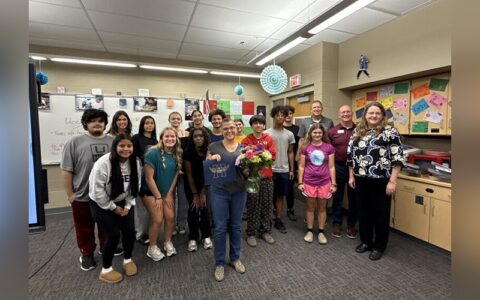 Lori Hill is surrounded by her class after receiving her award.