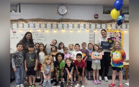 Jessica Ray is surrounded by her class after receiving her award.